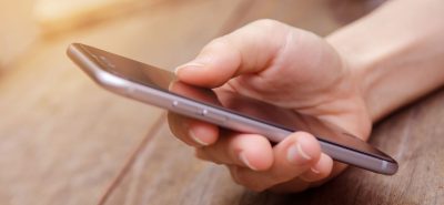 a close up of a person holding a cell phone.