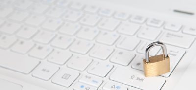 a padlock sitting on top of a computer keyboard.